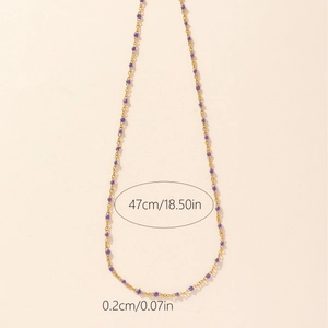 Golden chain necklace with purple enamel beads and size markings at 47cm length