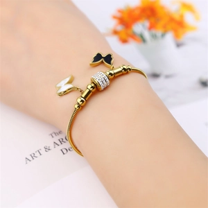 Elegant 18K gold-plated titanium steel bracelet featuring butterfly charms and crystal bead