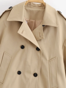 Detail of khaki trench coat collar and double-breasted buttons on twill fabric