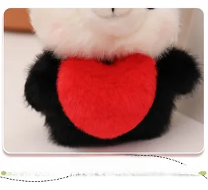 Close-up of plush panda toy featuring soft white fur and a red heart decoration