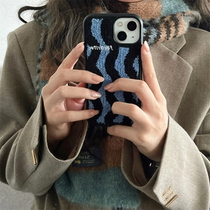 Detail of blue plush embroidered case with wave texture and favorite text for iPhone