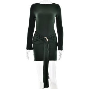 Detail of dark green mini dress featuring waist ruched design and golden metal ring detail