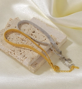 Detailed macro view of S925 sterling silver woven bracelet with lobster clasp and hallmark