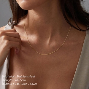 Detailed close-up of 14K gold plated stainless steel thin chain necklace on neck