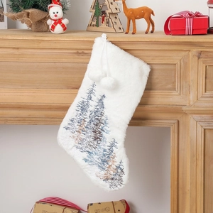 Close-up of plush white Christmas stocking with embroidered trees and fluffy pom-poms