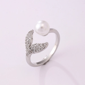 Detailed close-up of a silver mermaid tail ring with a pearl and sparkling zircons