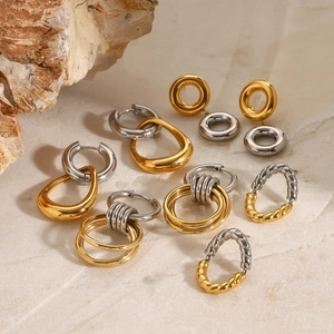 Two-tone gold and silver stainless steel hoop earrings set on marble stone