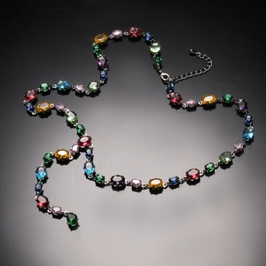 Macro shot of colorful oval-cut crystals set in a 18K gold-plated chain link necklace