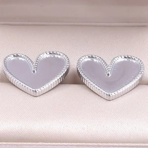 Macro shot of 304 stainless steel heart stud earrings with beaded edge and mother of pearl