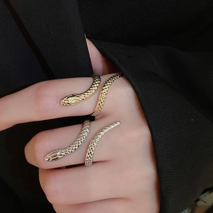 Detailed view of adjustable snake-shaped rings in gold and silver finish with scales