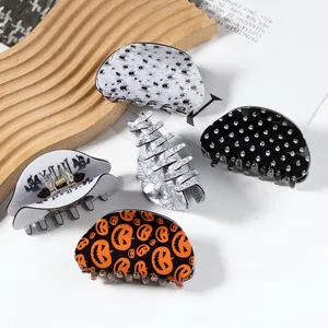 Set of 5 Halloween hair claws featuring pumpkin, skull, bat and spider web patterns