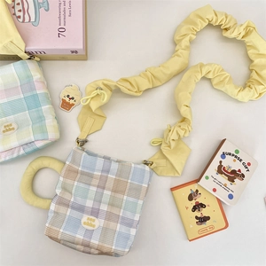 Detail of cute checkered water bottle bag with ruffled strap and round padded handle