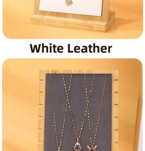 Detailed view of bamboo necklace display stand with various crystal heart and deer pendants