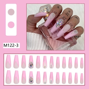 Detailed view of matte pink V-shape French press-on nails with sparkling rhinestones decoration