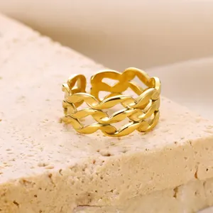 Detail of gold woven texture ring with three-layer wave design and adjustable opening