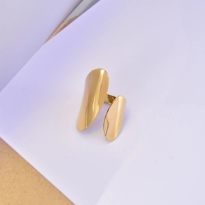 Macro detail of minimalist 18K gold plated open ring with modern asymmetric metal plates