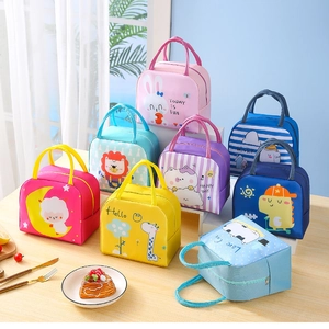 Variety of colorful cartoon insulated lunch bags with animal patterns on a wooden table