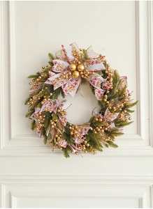 Close-up of a 50cm Christmas wreath with gold berries and gingerbread man ribbon details
