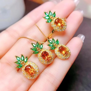 Pineapple jewelry set with orange stones and green crystals in gold plating