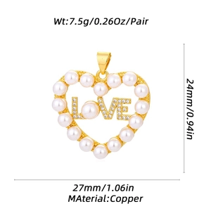 Golden heart pendant with inlaid pearls and crystals spelling LOVE on white background