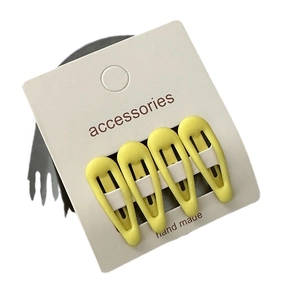 Set of 4 yellow star hair clips with matte finish for girls on a white card