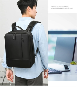 Detail showing ergonomic shoulder straps and multi-pocket design on black business backpack