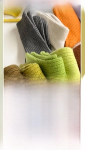 Close-up of thick knit wool socks in earthy colors showing soft ribbed texture