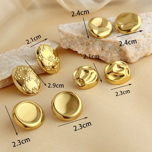 Set of vintage oval gold earrings in four styles shown on elegant satin background