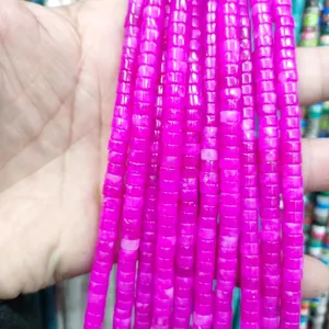 Close-up of polished rose red natural stone cylinder beads for DIY jewelry making