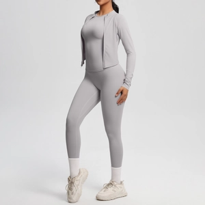 Detail of high-waisted quick-dry yoga leggings and slim-fit zip-up sports jacket