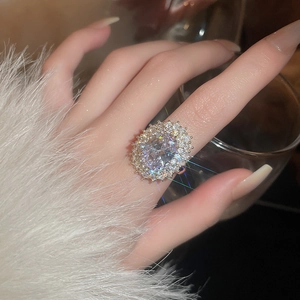 Macro shot of oval cubic zirconia ring with layered micro-pave setting on hand