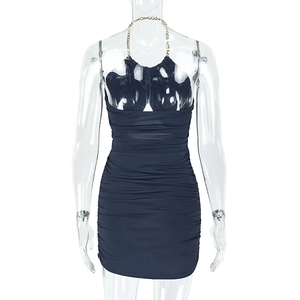 Detail of black bodycon mini dress featuring side ruching and golden neck chain