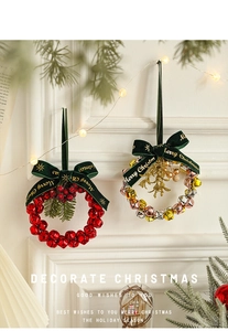 Close-up of Christmas wreath with red metal bells, velvet ribbons and pine needles