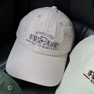 Close-up of bear embroidery and letter detailing on breathable cotton baseball caps