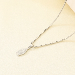 Detailed macro view of silver Virgin Mary pendant with polished box chain necklace