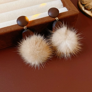 Winter plush earrings featuring round dark brown wood studs and soft beige pompom drops
