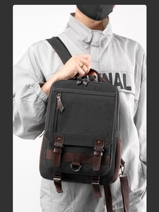Retro black canvas backpack with leather straps and multiple pockets for men and travel