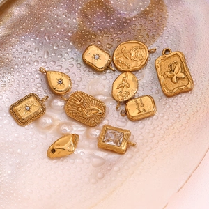 Detailed collection of vintage 18K gold plated charms with rose and star motifs