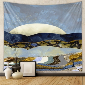 Close-up of abstract tapestry featuring blue mountains and gold marble textures on white wall