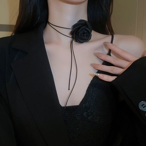 Detailed view of a black fabric rose choker necklace with elegant long ribbon fringe