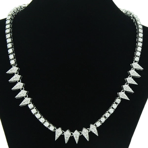 Silver geometric spiked tennis chain necklace with diamonds on a black mannequin