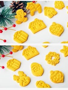 Flat lay of festive Christmas cookie cutters featuring gingerbread man and Santa shapes