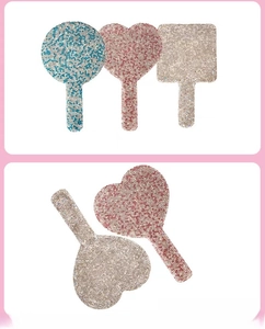 Macro view of rhinestone handheld makeup mirrors in heart, square, and round shapes