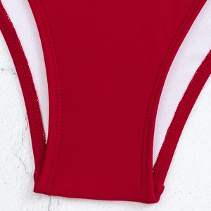 Detail view of red swimsuit bottoms with precise stitching and soft white lining