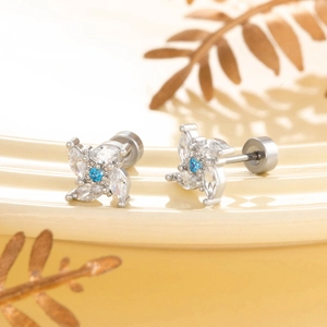 Silver windmill flower stud earrings with blue and white cubic zirconia and screw backs