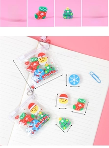 Detail view of Christmas erasers in zipper bags with Santa, tree, and snowflake shapes