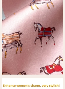Close-up of pink silk scarf with classical equestrian horse and saddle pattern prints