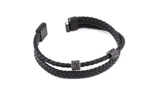 Detail of double-layer black braided leather bracelet with pavé-set cubic zirconia metal bars
