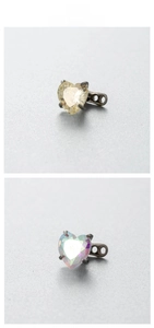 Detail view of 6mm heart-shaped zircon dermal anchors in yellow and AB white stones