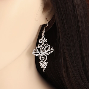 Elegant silver stainless steel hollow lotus hook earrings worn by a female model
